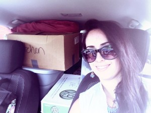 Picture of Chelsey in her car loaded with boxes